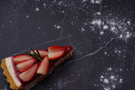 Photo of strawberry cake on a black backgroundの写真素材