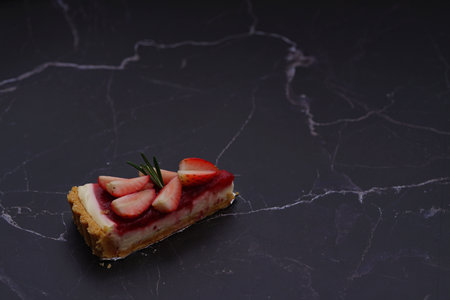 Photo of strawberry cake on a black backgroundの写真素材