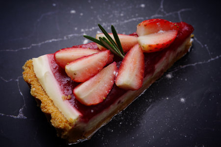 Photo of strawberry cake on a black backgroundの写真素材