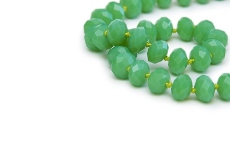 Necklace made of green beads isolated on whiteの写真素材