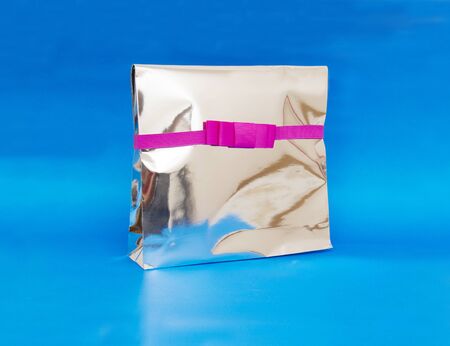gift box with pink ribbon bow, isolated on whiteの写真素材