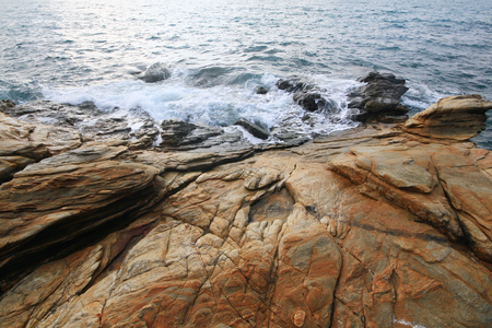 Rock texture and sun reflecting in waterの写真素材