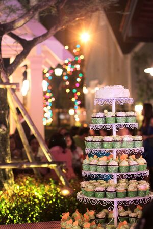 wedding cup cake with flowers at reception on Bokeh backgroundの写真素材