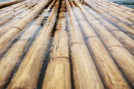 Sturdy raft made of bamboo submerged in the waterの写真素材
