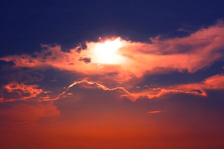 Dramatic golden light of sunray in sunset with clouds and sky background.
