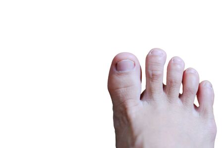 Closed up female feet with french nails on wood floor, Healthy care and medical conceptの写真素材