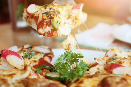 Slice of pizza cheese and seafood with sauce. Food of italian traditional.
