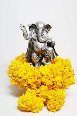 Ganesha god is the Lord of Success God of Hinduism on Marigold flowers Isolated on white background.の写真素材