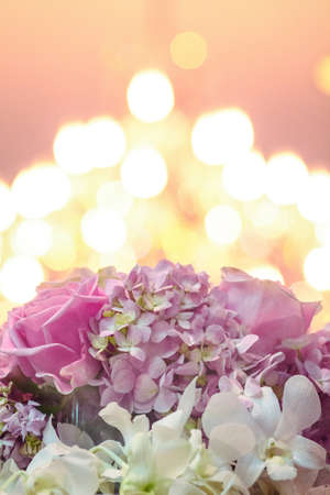 Beautiful blooming flowers on bokeh of candle light background in wedding ceremony.