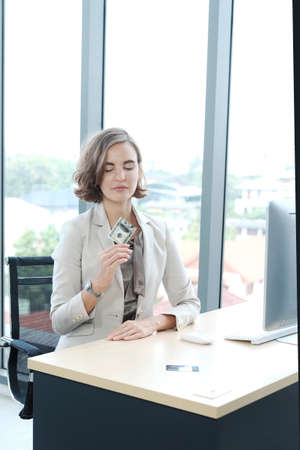Businesswoman in white suit hand holding Credit card and happy for pay about shopping timeの写真素材