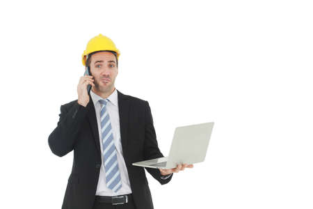 Handsome and smart engineer in black suit Wearing a yellow safety engineerking hat with hand holding...