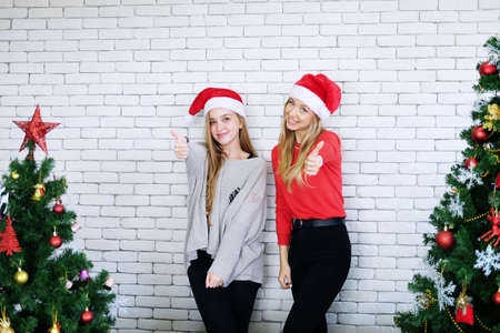 Smiling Caucasian Teenage girl Thumbs up and happy in Christmas party. Lifestyle of Lesbian on holiday and new year Conceptの写真素材