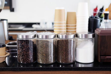Coffee bean and sugar in glass bottle decoration on counter is ingredients for making coffee mix at cafe.の写真素材