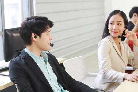 Business Call Center and technical Support staff or receptionist phone operator Discussing and...