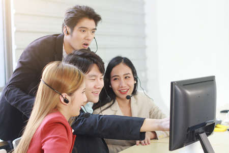 Business Call Center and technical Support staff or receptionist phone operator Discussing and working for teamwork with computer. Asian customer support team.の写真素材