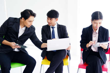 Asian successful businesspeople teamwork is meeting and brainstorming for Marketing business planning plan with laptop and tablet in meeting room at office. Seminar in the economics class.の写真素材
