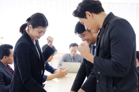 Successful Asian businesspeople are build powerful for success in the knowledge in the economics class bout business and stock market topics with Asian senior manger in meeting room at office.の写真素材