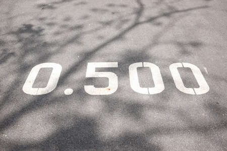 0.500 sign and symbol on concrete floor in the park is number and phase on road signの写真素材