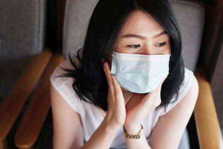 Asian woman is wearing mask prevent for covid-19 and infection corona virus or Air pollution pm 2.5. Virus outbreak in Thailandの写真素材