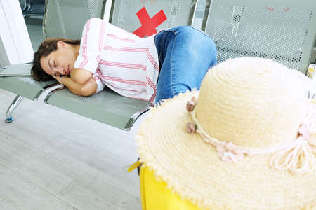 Caucasian traveler woman is sleeping on passenger While waiting to travel by plane in airport....