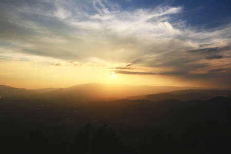 Beautiful landscape layers of mountain and Misty on hill valley in golden twilight of sunset at...