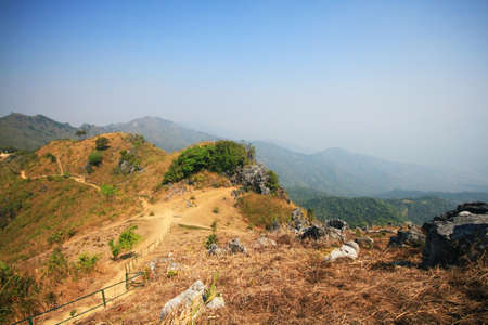Dry grassland and wild with blue sky on the valley mountain at Doi Pha Tang hill in Thailand