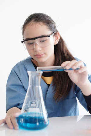 Smiling Caucasian student or pupil girl is study and test for chemical and science. She is...