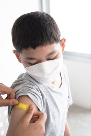 A Boy is wearing mask in the hospital. Vaccines for children to prevent COVID-19 in hospital.の写真素材