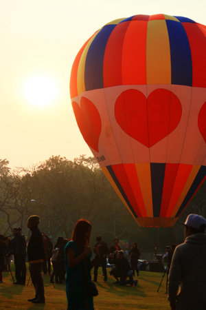 CHIANGRAI, THAILAND-FEBRUARY 14, 2016: Coloful Balloons on the ground with people and sunrise in Thailand International Balloon Festival at Singha Park Chiang Raiのeditorial素材