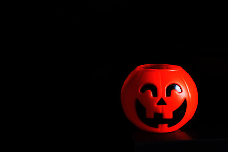Halloween pumpkin head with golden light in dark night bakckground. Halloween holiday concept.