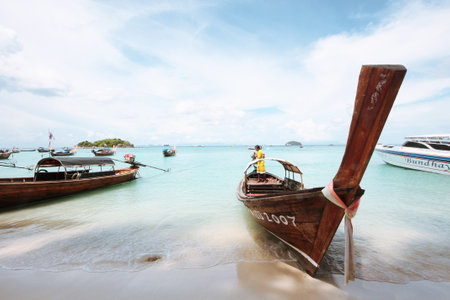 SATUN, THAILAND -May 08, 2012: Seascape of wooden tradition long tailed boat in the blue sea and...