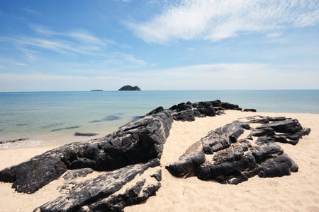 Beautiful seascape of the rocky beach and sea wave on seaside with blue sky at Samila beach in Thailandの写真素材