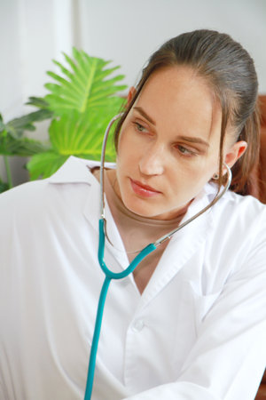 Caucasian Psychiatrist woman is checking heart wave by stethoscope with patient. Major depressive...