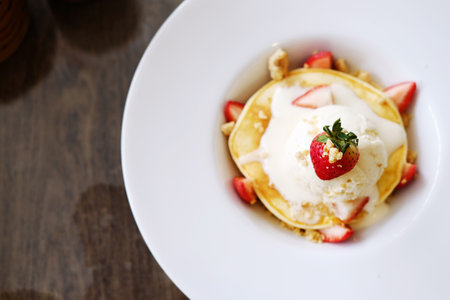 Homemade strawberry pancake with vanilla ice cream on white plate at cafe and bakery shop. Top viewの写真素材