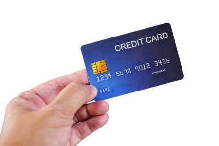 Close up woman hand holding credit card isolated on white background with clipping pathの写真素材