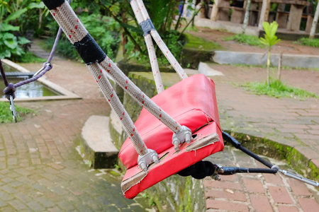 Close up Bali swing seat in tropical garden