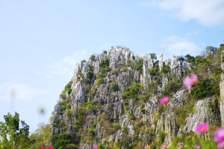 Landscape rocky mountain and tropical forest on hill with cloud and blue sky in Thailand