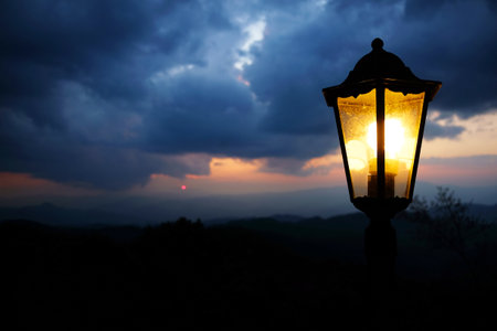Classic and vintage black iron street light in storm and dark cloud sky with twilight in the evening nighの写真素材