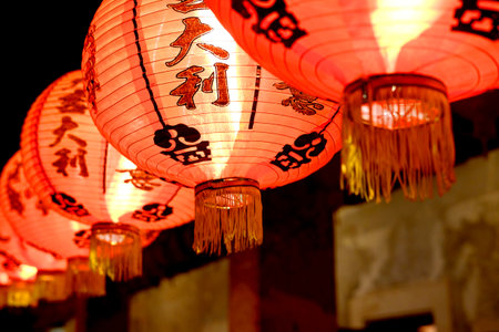 Close up beautiful red Chinese paper lantern with Chinese characters hanging on Chinese New Year...