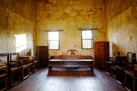 Antique old wooden furniture of Chinese style in vintage and rustic grunge concrete wall in living room with natural sunlight in Bangkok of Thailandの写真素材