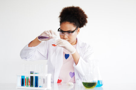 African American girl learning science and test chemical for liquid in the lab classroom of school....