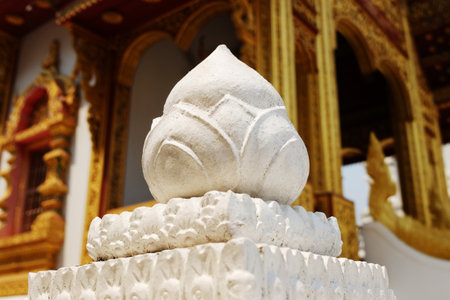 Floral statue and lotus stucco carvings decorated on pole head in the ancient golden templeの写真素材