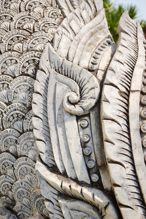 Details of the white stucco carving of the Naga are a reflection of the faith in Buddhism and the gods of Buddhists in Thailandの写真素材