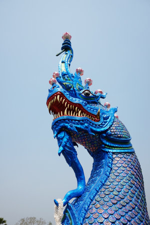 Beautiful blue Naga statue and ancient stucco art in front of at Ancient pagoda of buddhism in Thailandの写真素材