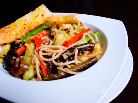 vegetarian pasta in olive oil with grlic breadの写真素材