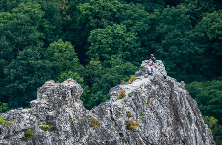 Two men climbing rocksの写真素材