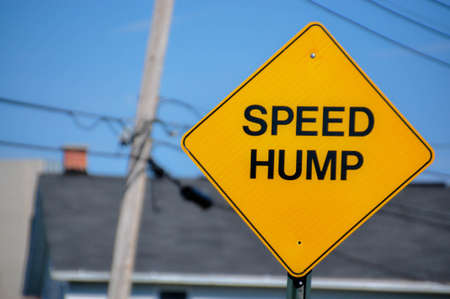 A sign warns of a speed hump aheadの写真素材
