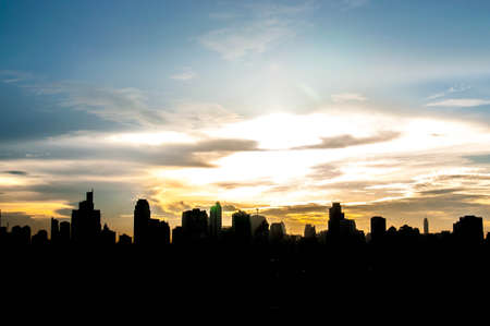 Sunset city scenery with sun and buildingsの写真素材