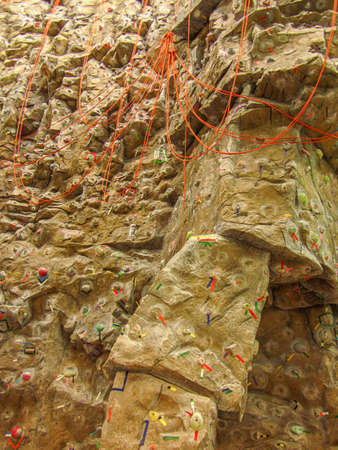 Grungy surface of an artificial rock climbing wall with toe and hand hold studs. の写真素材