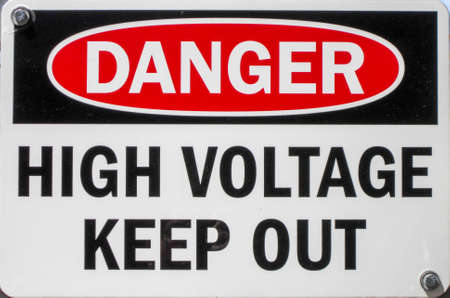 a sign stating of a high voltage danger and to keep out の写真素材